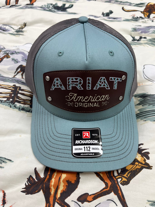 Leather Ariat patch on a teal/grey cap - Wines'Designs